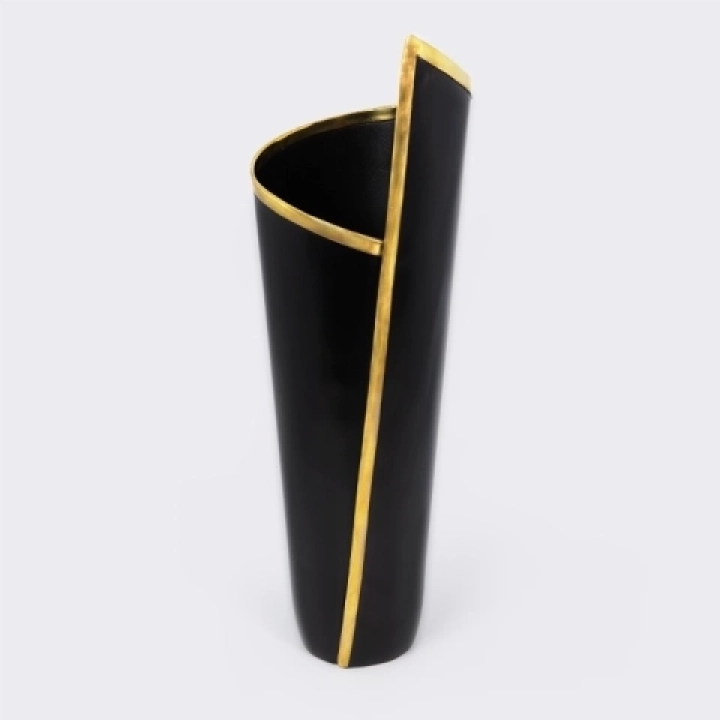 Handcrafted architectural vase with a pleated design, matte black finish, and gold brass trim.